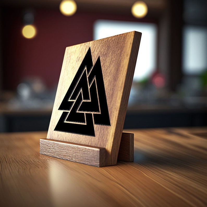 May include: A wooden sign with a black Valknut symbol, a Norse symbol representing the connection between the realms of the gods, the living, and the dead. The sign is on a wooden stand.