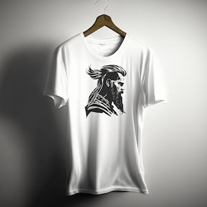 May include: White t-shirt with a black and white graphic of a man with a beard and long hair.