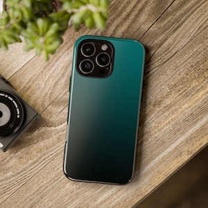 May include: A dark green and black gradient phone case with a camera lens cutout.