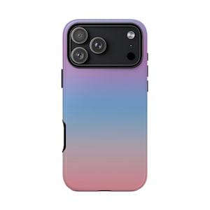 May include: A smartphone case featuring a smooth gradient design that transitions from a soft purple at the top to a light blue in the center and a muted pink at the bottom. The case includes a black rectangular camera cutout with three lenses.