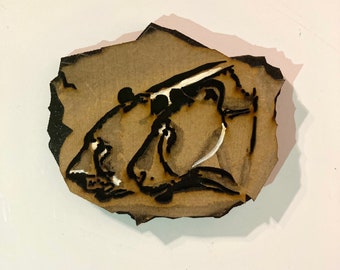 Wooden fridge magnet engraved with prehistoric lions, rock chip style