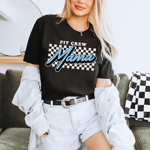 a woman sitting on a couch wearing a black shirt