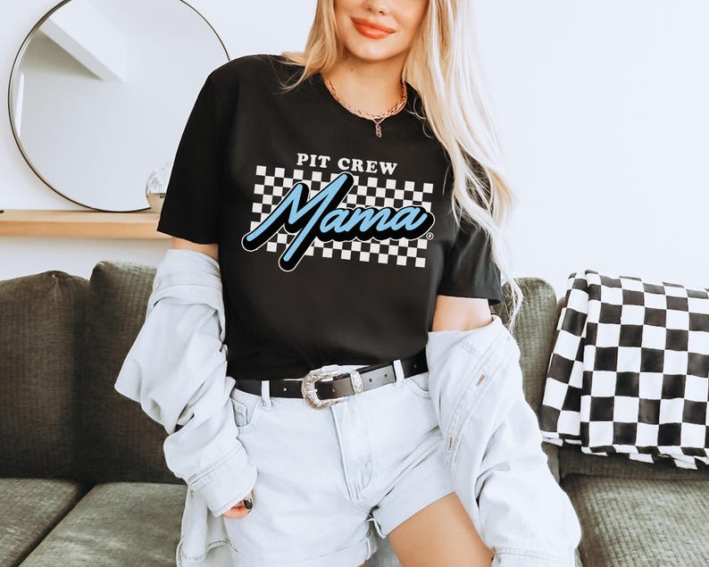 a woman sitting on a couch wearing a black shirt