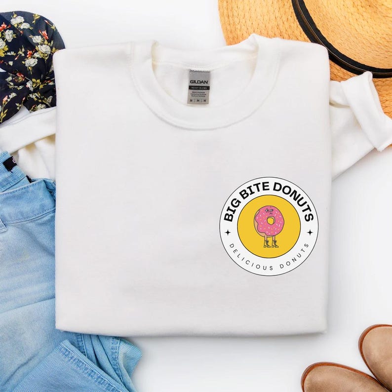a white t - shirt with a donut sticker on it