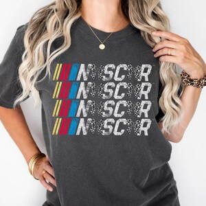a woman wearing a black shirt with the word nascar on it