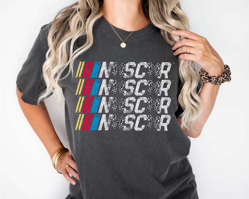 a woman wearing a black shirt with the word nascar on it
