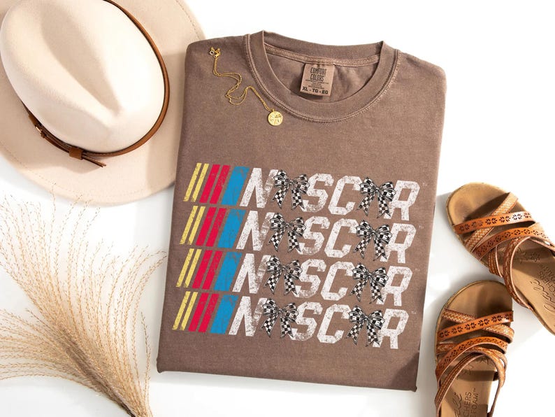a t - shirt with the words nascar on it next to a pair of shoes