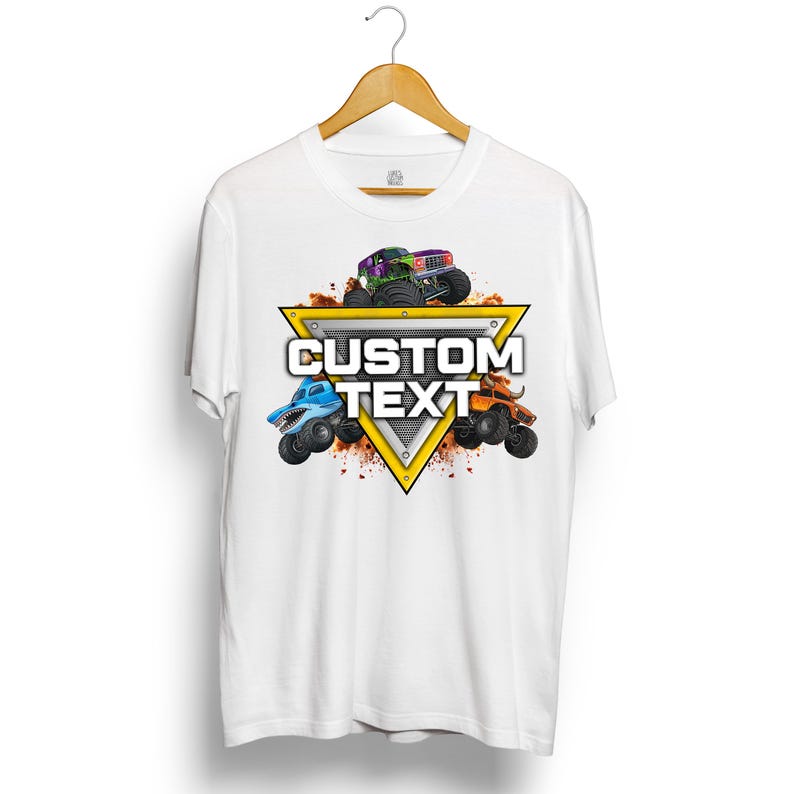 Puede incluir: Camiseta blanca con un gr&aacute;fico de tres monster trucks en verde, azul y naranja. Los camiones est&aacute;n colocados alrededor de un tri&aacute;ngulo amarillo con las palabras "CUSTOM TEXT" en blanco. El dise&ntilde;o incluye tierra y un fondo met&aacute;lico.