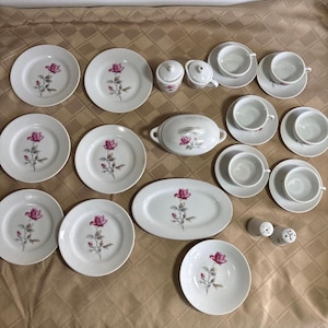 May include: A set of three ceramic mugs with a speckled, matte finish. The mugs are in shades of cream, light gray, and dark gray. Each mug has a simple, minimalist design, perfect for coffee or tea.