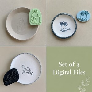 May include: A collection of three ceramic plates featuring cat designs and corresponding stamps. The plates have white surfaces with grey or blue rims. The stamps are green, blue, and black. The text "Set of 3 Digital Files" is displayed.