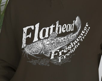 May include: A brown hoodie with a white graphic of a catfish and the text "Flathead Freshwater Freight Train".