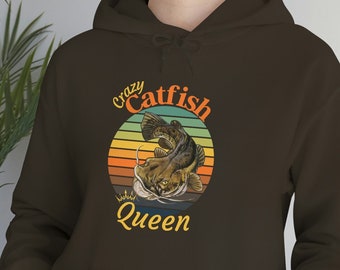 May include: Brown hoodie with a vintage-style graphic of a catfish with the text "Crazy Catfish Queen".