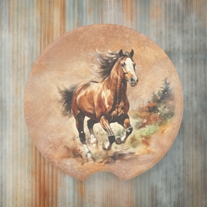 May include: A brown horse with a white blaze on its face runs through a field of green grass and brown dirt. The horse has a long flowing mane and tail. The background is a blurred image of trees and sky.