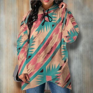 May include: A long-sleeved hooded sweatshirt with a geometric pattern in shades of pink, blue, and brown. The pattern is reminiscent of Native American art.