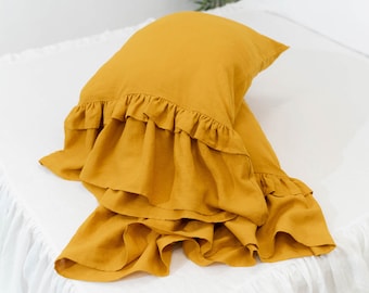 Double-ruffled linen pillow case and pillow shams with a slipcover design are available in standard, queen, and California king sizes