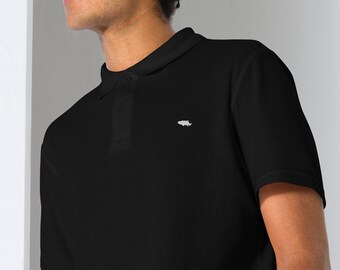 May include: Black polo shirt with a white fish emblem on the chest. The shirt has a classic collar and a three-button placket. The short-sleeved shirt is made of a soft, comfortable material.