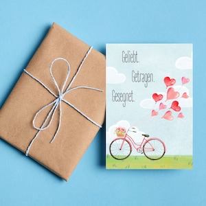 christliche Postkarte - Geliebt. Getragen. Gesegnet. | Fahrrad mit Herz-Luftballons | Aquarell