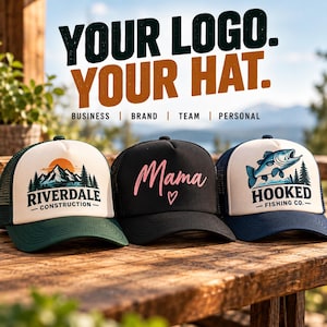 May include: Three trucker hats with mesh backs. The left hat is green and white with a mountain graphic and text reading RIVERDALE CONSTRUCTION. The center hat is black with pink text reading Mama and a heart. The right hat is blue and white with a fish graphic and text reading HOOKED FISHING CO. Above the hats, text reads YOUR LOGO. YOUR HAT. BUSINESS | BRAND | TEAM | PERSONAL.