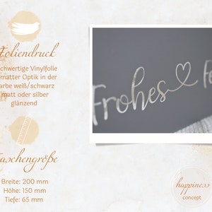 May include: A silver vinyl sticker with the text "Frohes & Fest" in a cursive font. The sticker is on a gray background. The sticker is 8 inches wide and 6 inches tall.