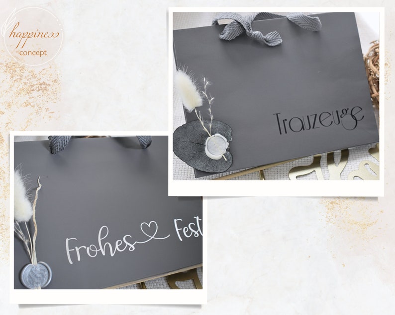 May include: Two gray gift bags with white lettering. One bag says "Frohes Fest" with a heart symbol. The other bag says "Trauzeuge".