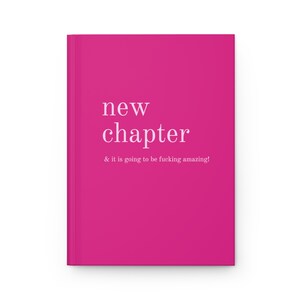 May include: A pink notebook with the text "new chapter & it is going to be fucking amazing!" printed in white.