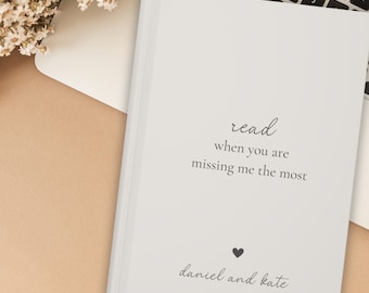 May include: A white journal with the text "read when you are missing me the most" and a heart symbol. The names "daniel and kate" are written below the heart.