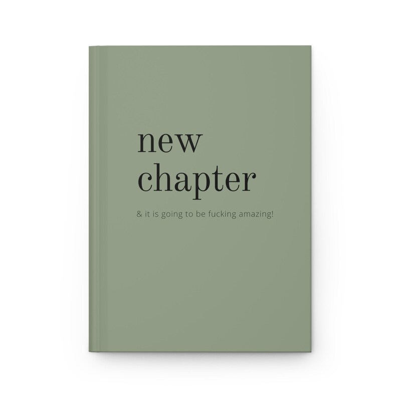 May include: A sage green journal with the text "new chapter" and the phrase "& it is going to be fucking amazing!" printed in black.
