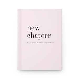 May include: A pink notebook with the text "new chapter & it is going to be fucking amazing!" printed on the front.