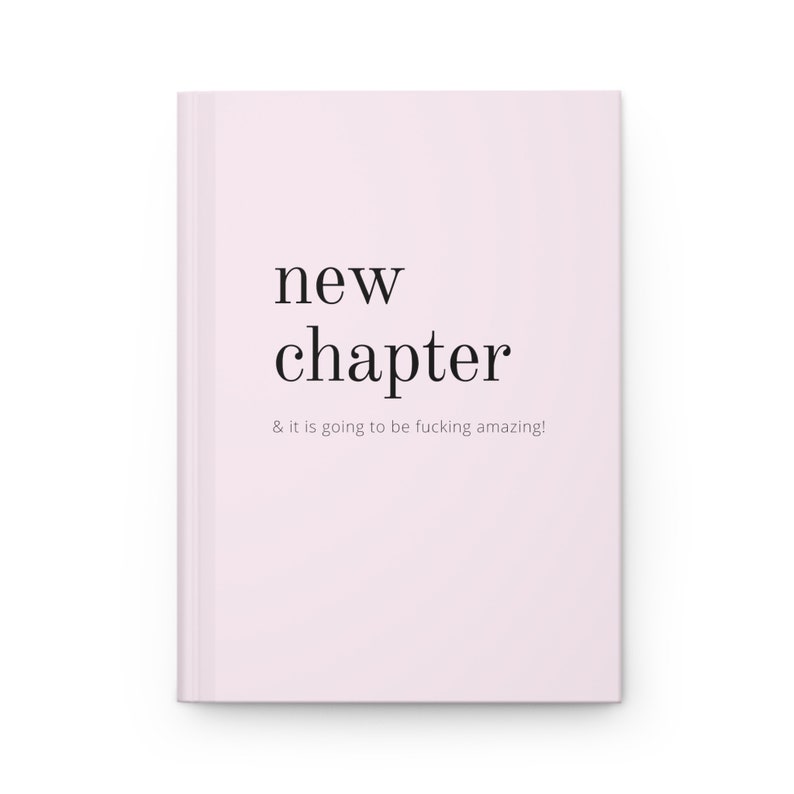 May include: A pink notebook with the text "new chapter & it is going to be fucking amazing!" printed on the front.