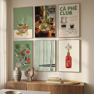 May include: A gallery wall featuring six framed prints with culinary themes, including illustrations of pho, Vietnamese coffee, fresh ingredients, noodles, and a hot sauce bottle with the text CÀ PHÊ CLUB SERVED FRESH EVERY MORNING.