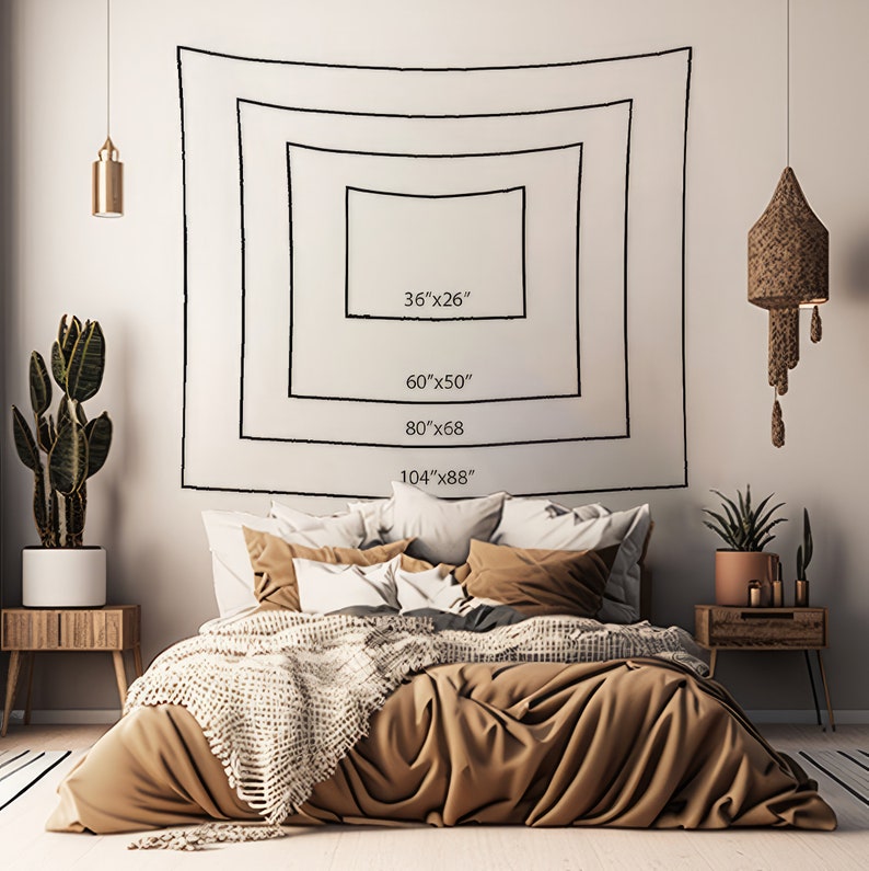May include: A wall tapestry size guide featuring four nested rectangular outlines with the dimensions 36"x26", 60"x50", 80"x68", and 104"x88" printed in black ink on a plain white background, displayed above a bed with brown and white bedding.