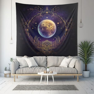 May include: A tapestry featuring a large, full moon with a detailed, intricate gold mandala design surrounding it. The moon is a vibrant blue and gold colour, with a dark blue background and stars.