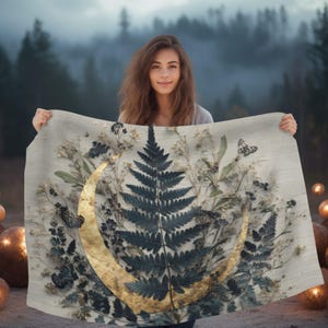 May include: A rectangular textile wall hanging featuring a central dark green fern leaf surrounded by dried botanical elements and two butterflies. A large, textured gold crescent moon shape overlays the foliage on a light beige fabric background.