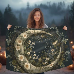 May include: A rectangular dark green tapestry featuring a large, central crescent moon shape adorned with intricate white floral illustrations, green leaves, and delicate botanical vines, framed by a circular gold-toned decorative border.