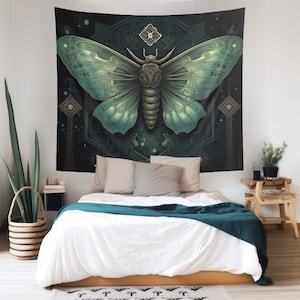 May include: A tapestry featuring a detailed illustration of a green and brown moth with intricate patterns on its wings. The moth is set against a dark background with a geometric design and stars.