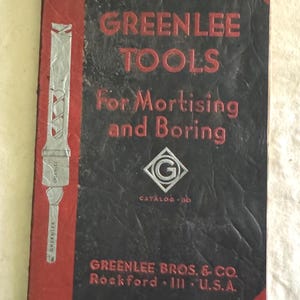 May include: A vintage Greenlee Tools catalogue cover. The black cover has red accents and the text "GREENLEE TOOLS For Mortising and Boring." Includes a silver illustration of a tool and the company's name and location.