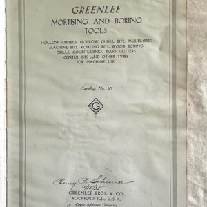 May include: An aged catalog cover for Greenlee Mortising and Boring Tools. The cover features a title, a list of tools, and the company's name and address. The catalog number is 30. The cover is off-white with a gray border.
