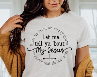 May include: A white t-shirt with a black graphic that reads "Rises up from an empty grave Let me tell ya 'bout My Jesus No sinner that He can't save".