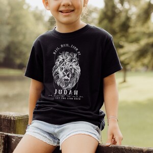 May include: A black t-shirt with a white lion graphic and the text "Hail, Lion of Judah. Let the Lion Roar."