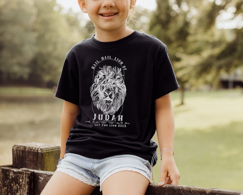May include: A black t-shirt with a white lion graphic and the text "Hail, Lion of Judah. Let the Lion Roar."