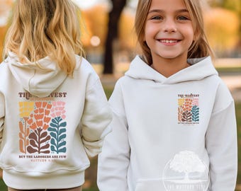 May include: White hooded sweatshirt with a colorful floral design and the text "The Harvest is plentiful, but the laborers are few, Matthew 9:37".