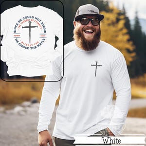 May include: White long-sleeve shirt with a cross design made of nails. The shirt features the text "SINCE HE COULD NOT STAND THE THOUGHT OF ETERNITY" and "HE CHOSE THE NAILS" with the Bible verse John 15:13.