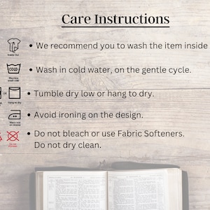 May include: Care instructions for a garment. The instructions include washing, drying, ironing, and bleaching. The instructions recommend washing the item inside out, in cold water on a gentle cycle, and tumble drying low or hanging to dry. The instructions also recommend avoiding ironing on the design, not bleaching, and not dry cleaning.