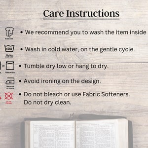 May include: Care instructions for a garment. The instructions include washing, drying, ironing, and bleaching. The instructions recommend washing the item inside out, in cold water on a gentle cycle, and tumble drying low or hanging to dry. The instructions also recommend avoiding ironing on the design, not bleaching, and not dry cleaning.