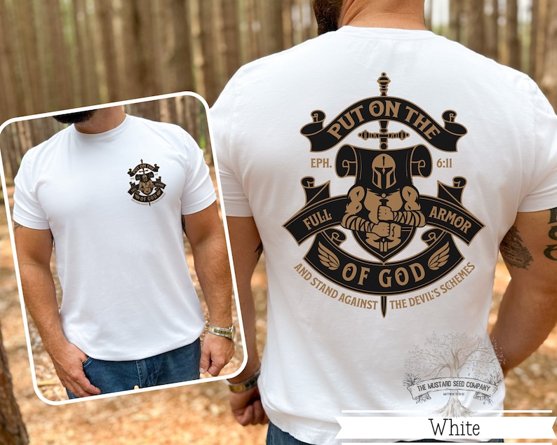 May include: White t-shirt with a black and gold graphic design featuring a knight in armor with a sword and the text "Put on the Full Armor of God" and "Eph. 6:11" and "And Stand Against the Devil's Schemes".