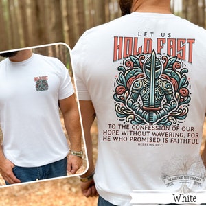 May include: White t-shirt with a graphic of a knight holding a sword and the text "Let us hold fast to the confession of our hope without wavering, for he who promised is faithful. Hebrews 10:23". The shirt also has the text "The Mustard Seed Company" at the bottom.