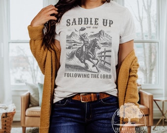 Saddle Up We Are Following Jesus Christian Womens Tshirt Vintage Western Shirt for Her Cute Trendy Christian Tee Following Jesus Western Tee