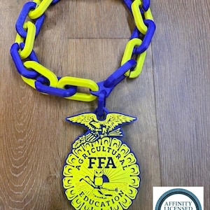 May include: A necklace featuring a chain of alternating bright yellow and royal blue plastic links. A large, circular pendant hangs from the chain, displaying the FFA emblem with an eagle, owl, and the text Agricultural Education FFA in yellow and blue.
