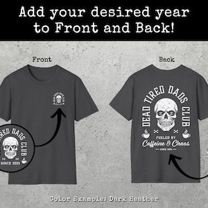 May include: A dark heather gray t-shirt featuring a small skull graphic on the front left chest and a large skull graphic on the back. The back design includes the text Dead Tired Dads Club, Fueled by Caffeine & Chaos, and Since 2021.