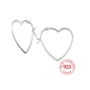 May include: Sterling silver heart-shaped hoop earrings. The earrings have a textured diamond pattern. The earrings are marked "925" and "REAL STERLING SILVER".